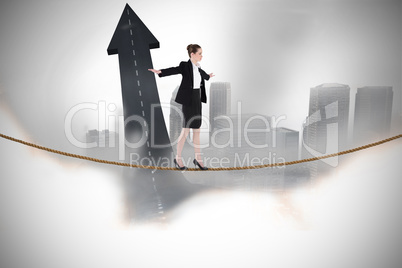 Composite image of businesswoman performing a balancing act