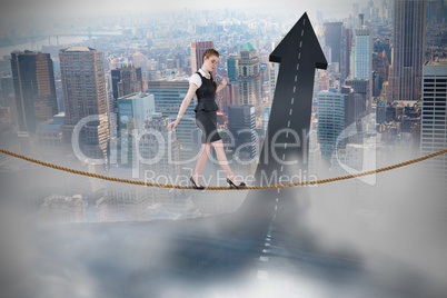 Composite image of businesswoman doing a balancing act