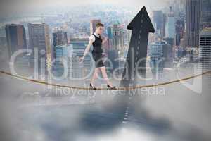 Composite image of businesswoman doing a balancing act