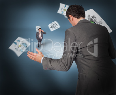 Composite image of businessman posing with hands out with tiny b