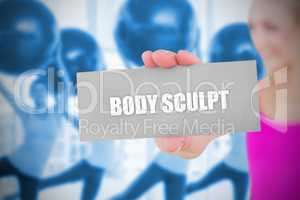 Fit blonde holding card saying body sculpt