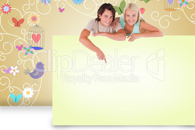 Composite image of attractive couple showing card