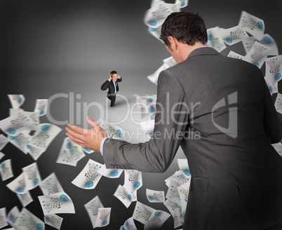 Composite image of businessman posing with hands out with tiny b