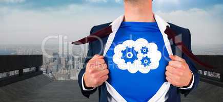 Composite image of businessman opening his shirt superhero style