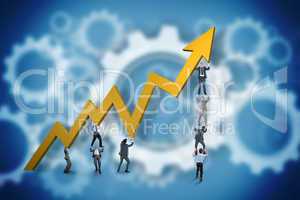 Composite image of business team holding up arrow