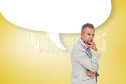 Composite image of thinking businessman with speech bubble