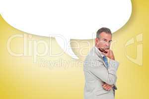 Composite image of thinking businessman with speech bubble