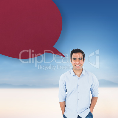 Composite image of smiling casual man standing with speech bubbl