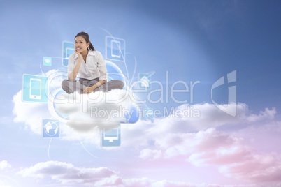 Composite image of businesswoman sitting cross legged thinking