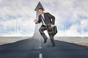 Composite image of cheerful businessman in a hurry