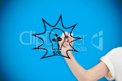 Composite image of businesswoman drawing light bulb