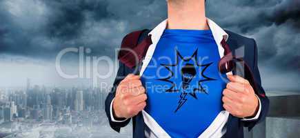 Composite image of businessman opening his shirt superhero style