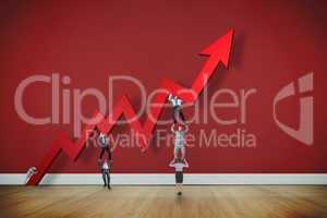 Composite image of business team holding up arrow