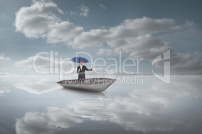 Composite image of peaceful businessman holding blue umbrella in