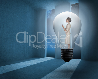 Composite image of thinking businesswoman in light bulb