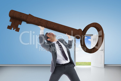 Composite image of unsmiling businessman carrying large key