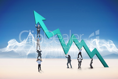 Composite image of business team holding up arrow