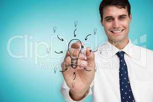 Composite image of businessman drawing light bulb