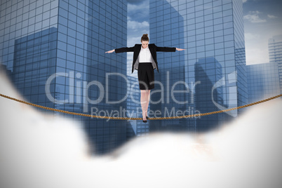 Composite image of businesswoman performing a balancing act