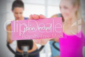 Fit blonde holding card saying join now