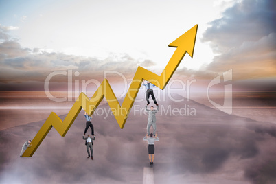 Composite image of business team holding up arrow