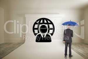 Composite image of businessman holding umbrella