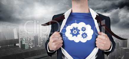 Composite image of businessman opening his shirt superhero style