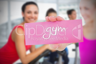 Fit blonde holding card saying gym Fit blonde holding card saying gym