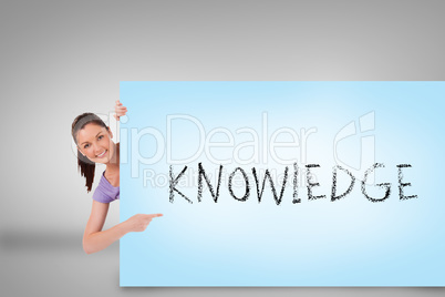 Pretty brunette showing card with knowledge