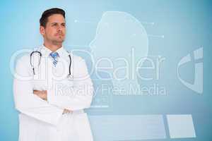 Composite image of handsome doctor with arms crossed