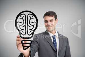 Composite image of businessman drawing light bulb