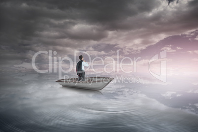 Composite image of businessman holding his jacket in a sailboat