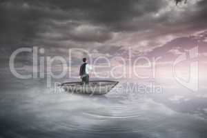 Composite image of businessman holding his jacket in a sailboat