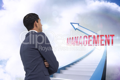 Management against red staircase arrow pointing up against sky
