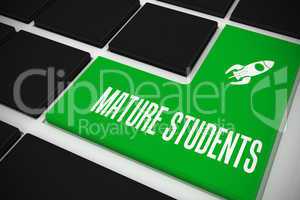 Mature students on black keyboard with green key