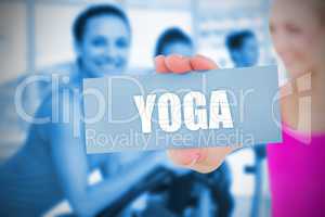 Fit blonde holding card saying yoga