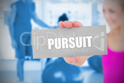 Fit blonde holding card saying pursuit