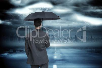 Composite image of rear view of classy businessman holding grey