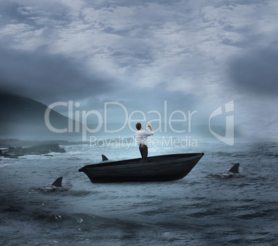 Composite image of businessman posing with arms up in a sailboat