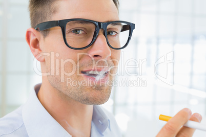 Casual businessman smoking an electronic cigarette
