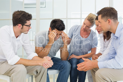 Group therapy in session sitting in a circle