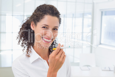 Casual businesswoman smoking an electronic cigarette