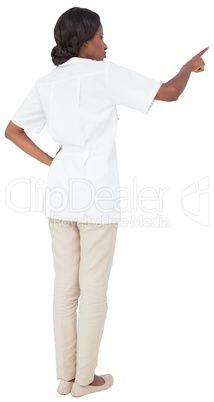 Young nurse in tunic pointing
