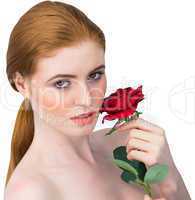 Beautiful redhead posing with red rose