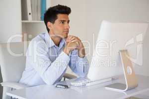 Casual businessman concentrating at his desk