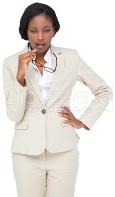 Thinking businesswoman in cream suit