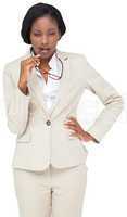 Thinking businesswoman in cream suit