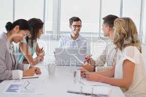 Casual businessman talking to team during meeting