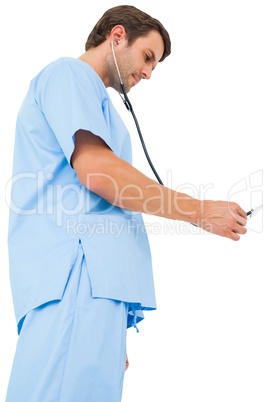 Handsome surgeon in blue scrubs using stethoscope