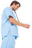 Handsome surgeon in blue scrubs using stethoscope